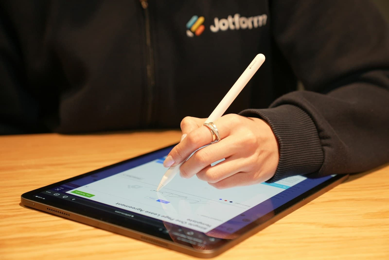 Business owner signing an electronic document on a tablet