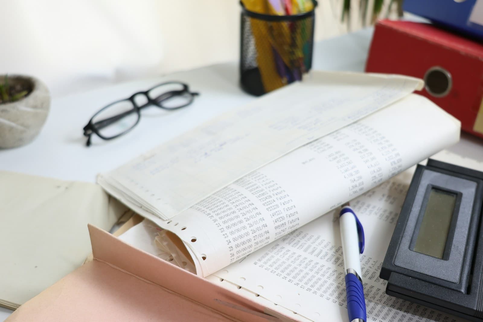 Calculator, glasses and financial papers on an accountant's desk